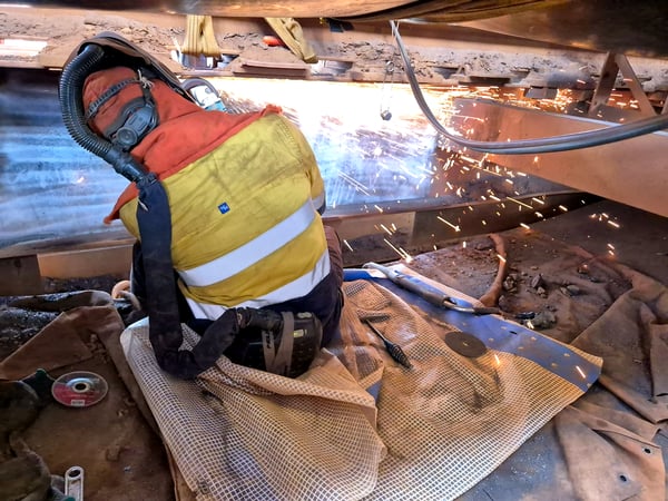 Worker in high-vis safety gear inside the Tom Price screen house