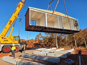 Crane lifting a modular building